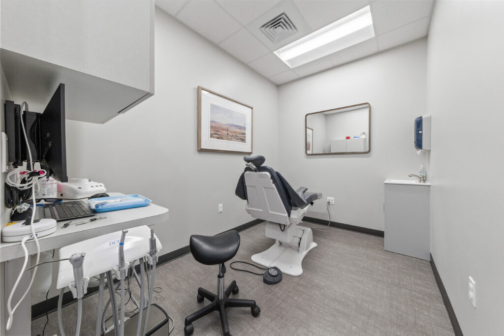 Dental treatment room with patient chair, digital monitor, and modern equipment at Morgan Family Dentistry Lafayette designed by A Beazley Architecture